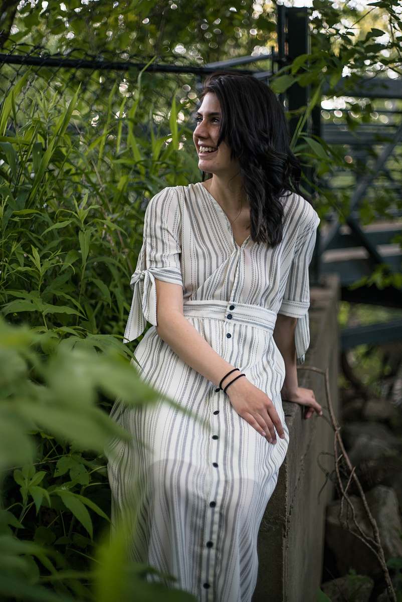 clothing smiling woman wearing white and grey striped dress evening dress
