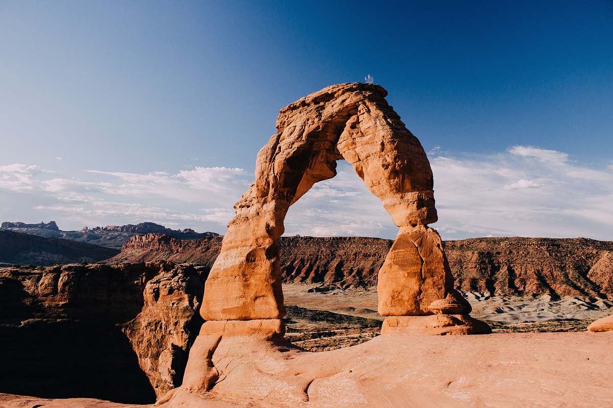 arched landscape photography of rock formation architecture