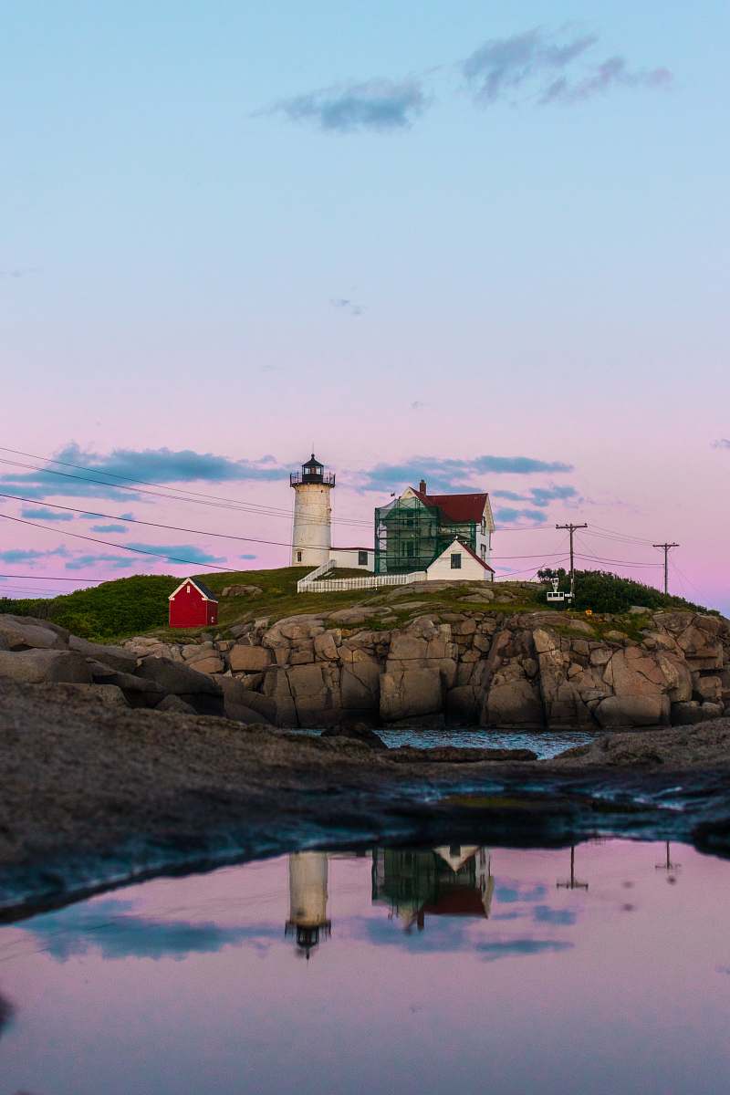 building house beside lighthouse tower