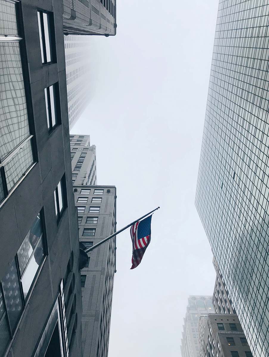 building worm's-eye view photography of flag of American city