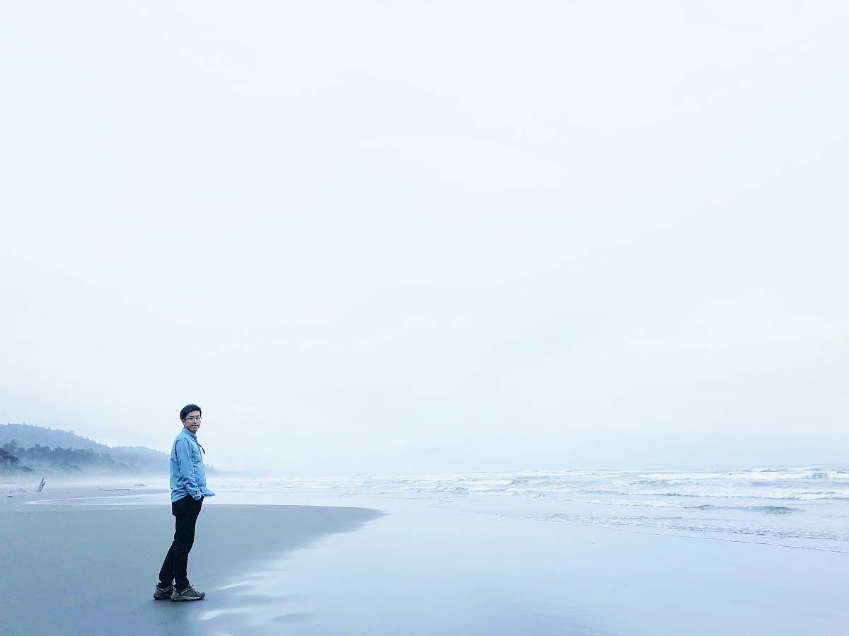 blue man standing at sea side during cloudy skies kalaloch beach