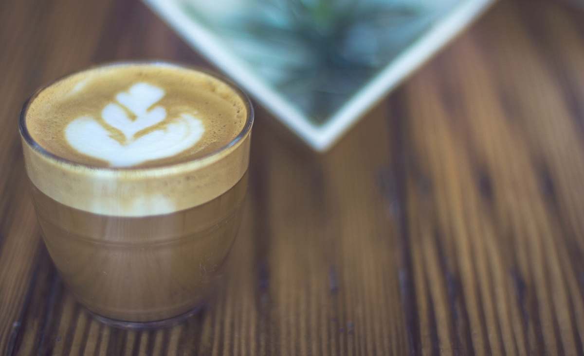 drink macro photography of latte in drinking glass coffee cup