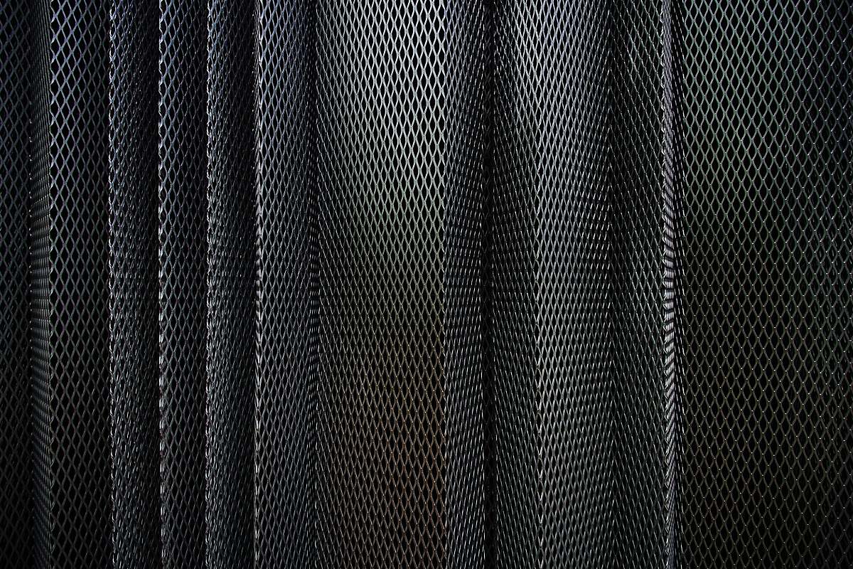 texture A metal criss-cross grid in undulating layers pattern