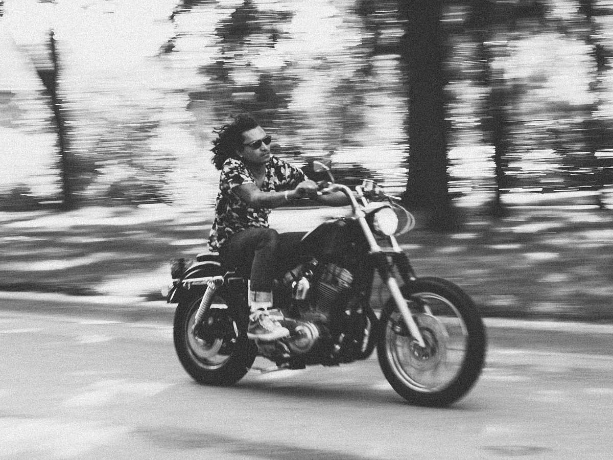vehicle grayscale photo of man riding motorcycle transportation