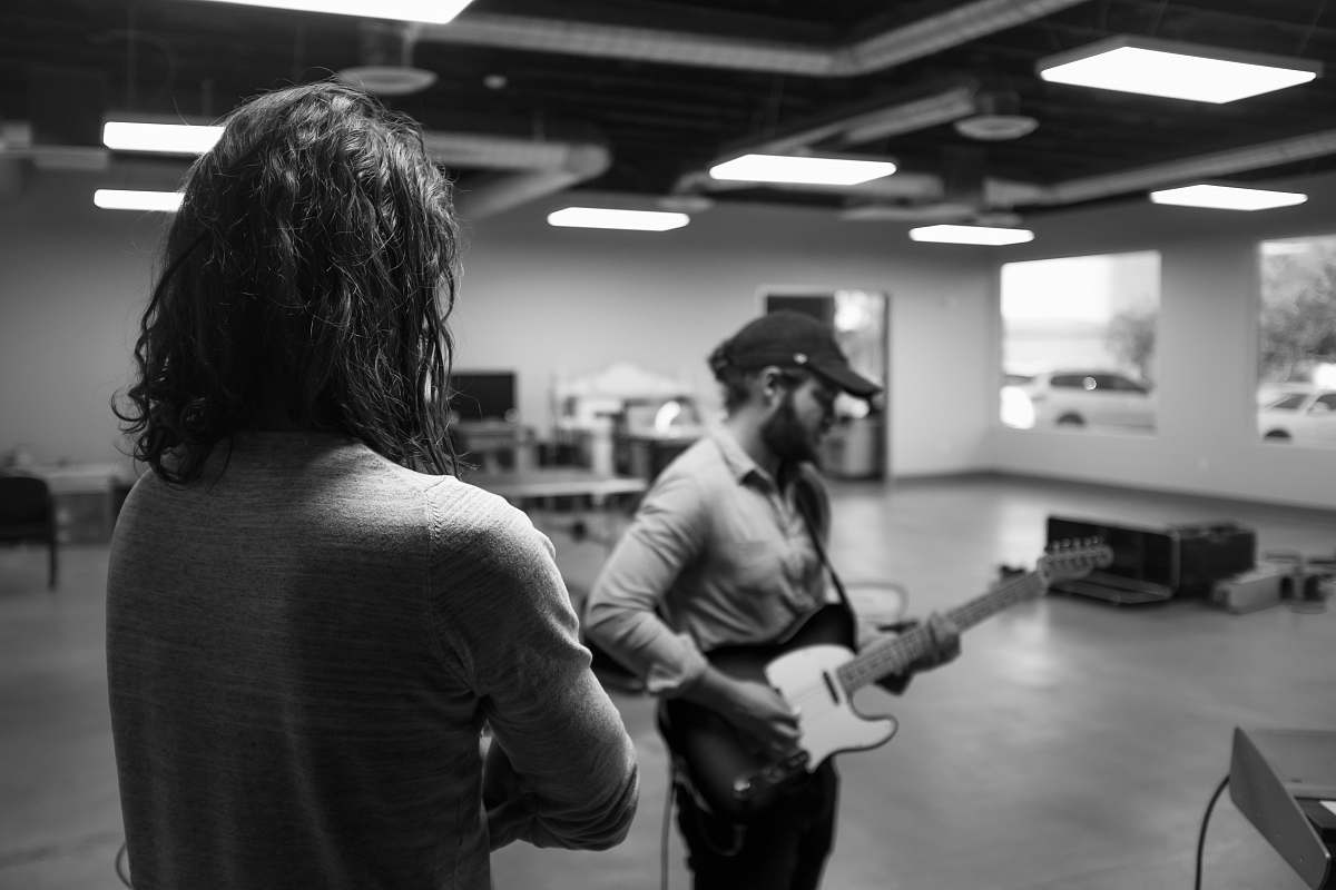 person man playing guitar grayscale photo human
