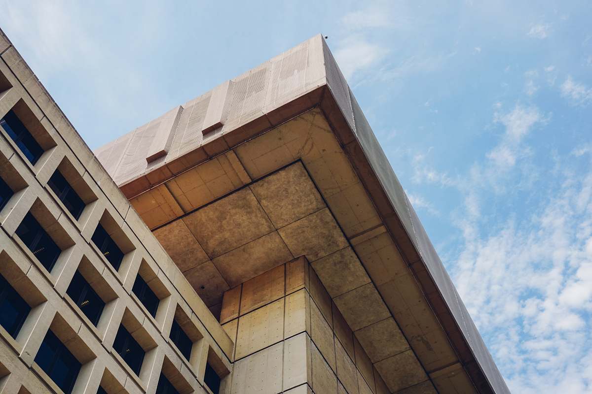 architecture brown concrete building under blue sky during daytime office building