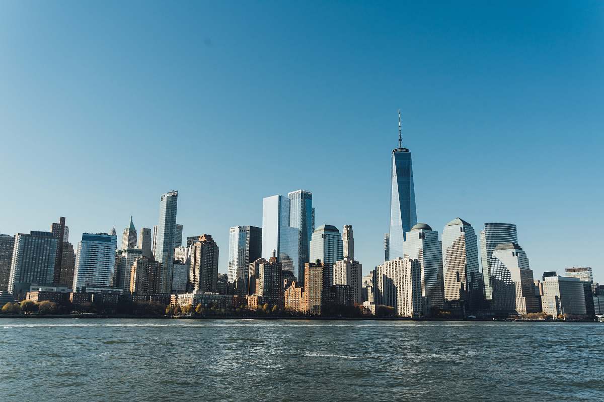 city city building near body of water under blue sky urban