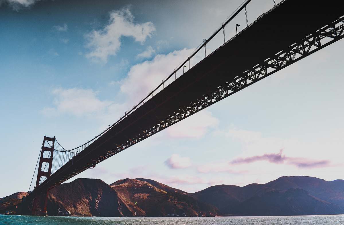 mountain Golden Gate Bridge under cloudy sky during daytime bridge