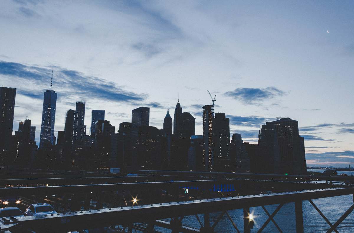 city lighted building under white clouds and blue sky urban