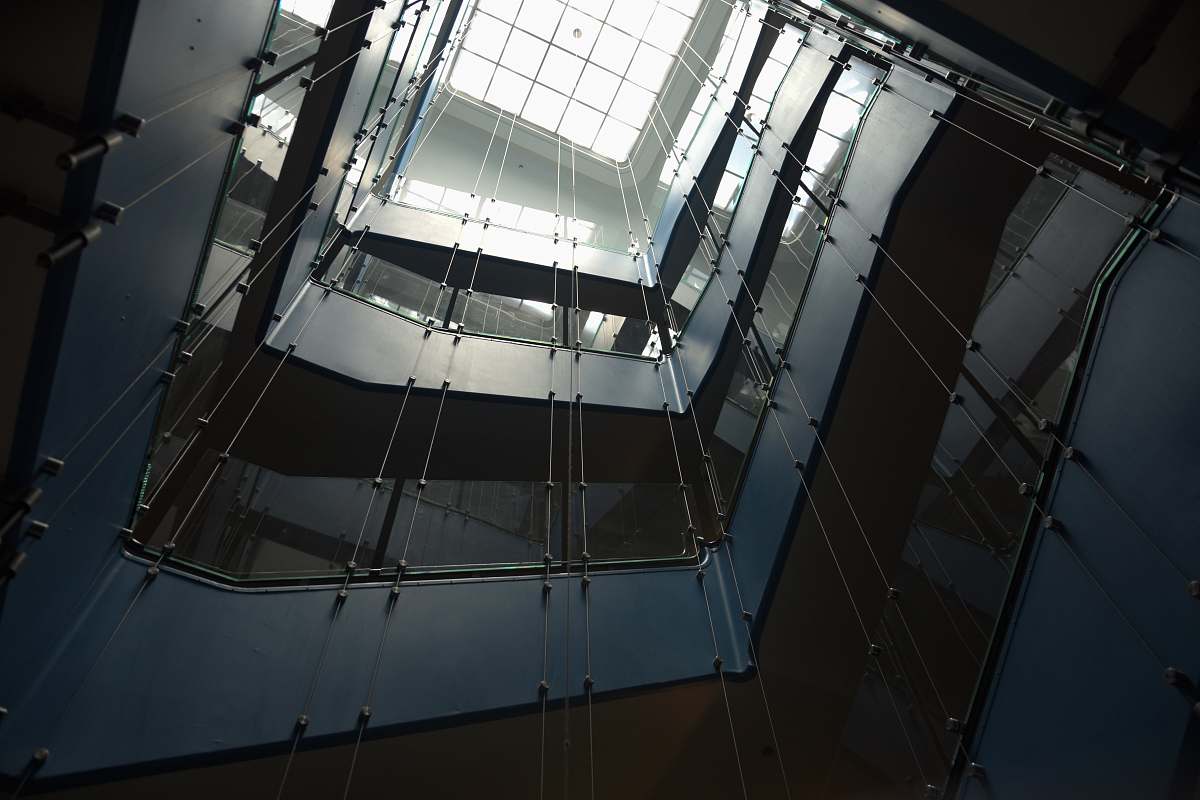 architecture low-angle photography of multi-storey building with glass ceiling window