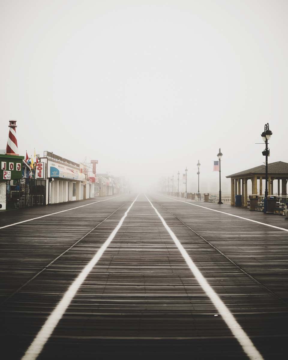 boardwalk pathway between gazebo and stores surrounded by fogs bridge