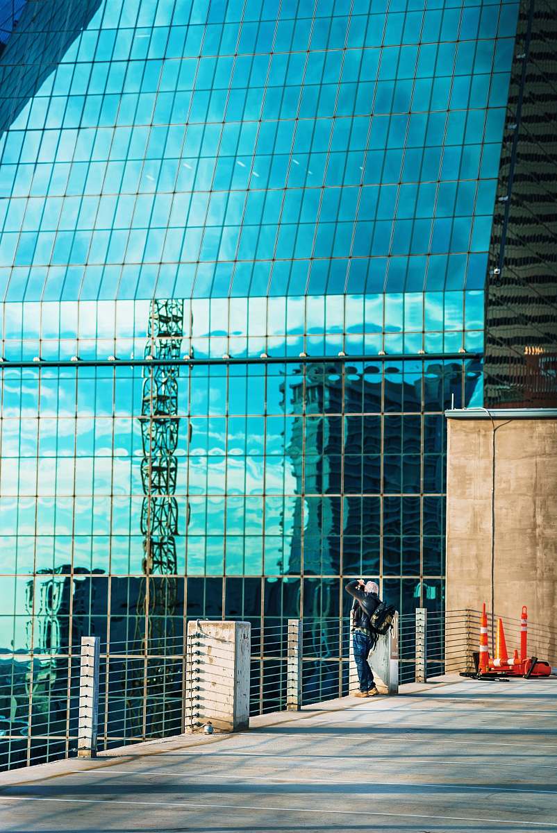 architecture woman standing on fence during daytime convention center