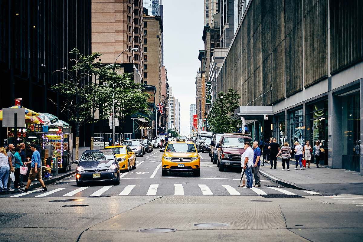 cab city street with people passing through road taxi