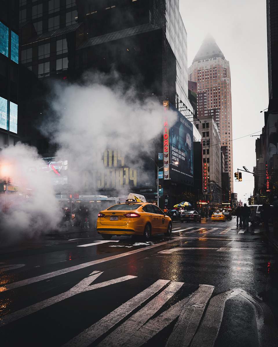 cab yellow taxi sedan on gray concrete street passed through white smokes near walking lane taxi