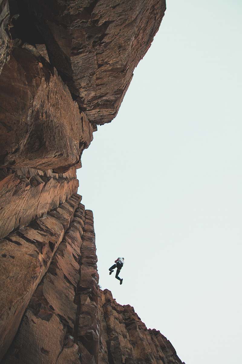 outdoors person climbing mountain during daytime vantage