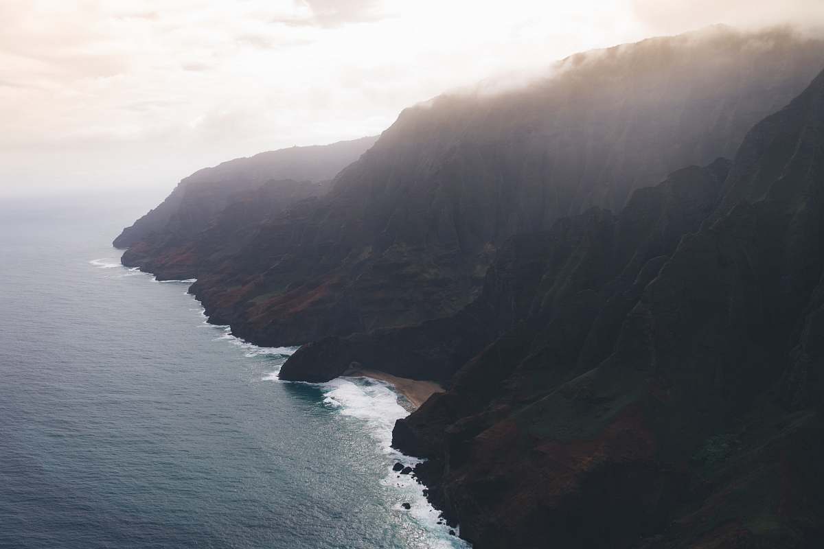 outdoors brown mountains under gray sky during daytime cliff