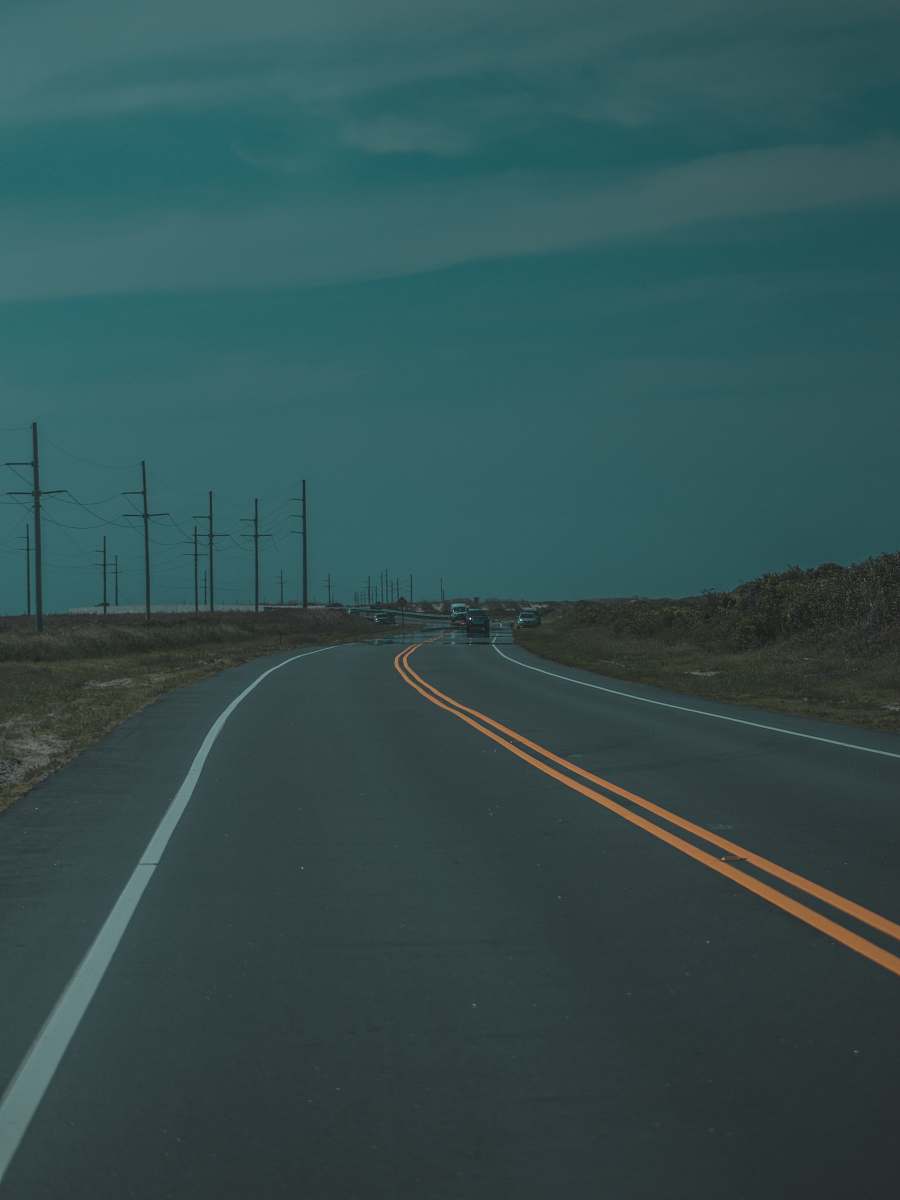 road low light photography of asphalt road under cloudy sky freeway