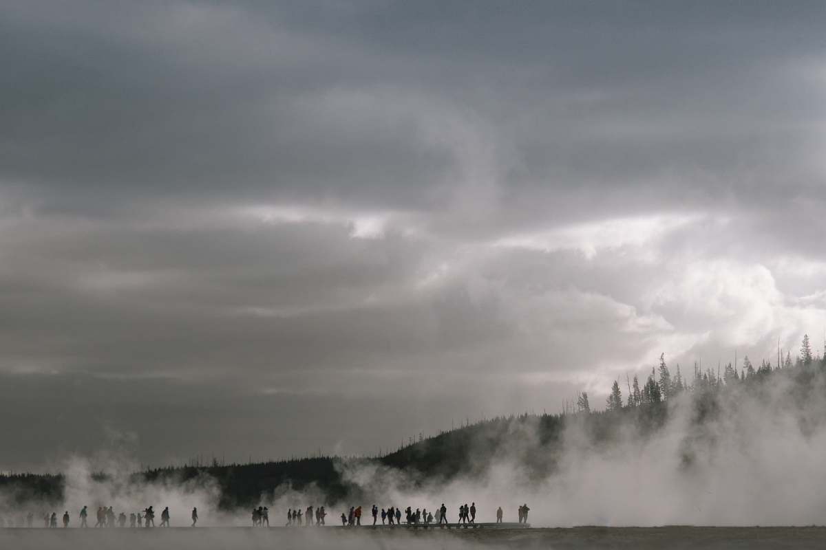 steam people near mountain with fogs yellowstone national park