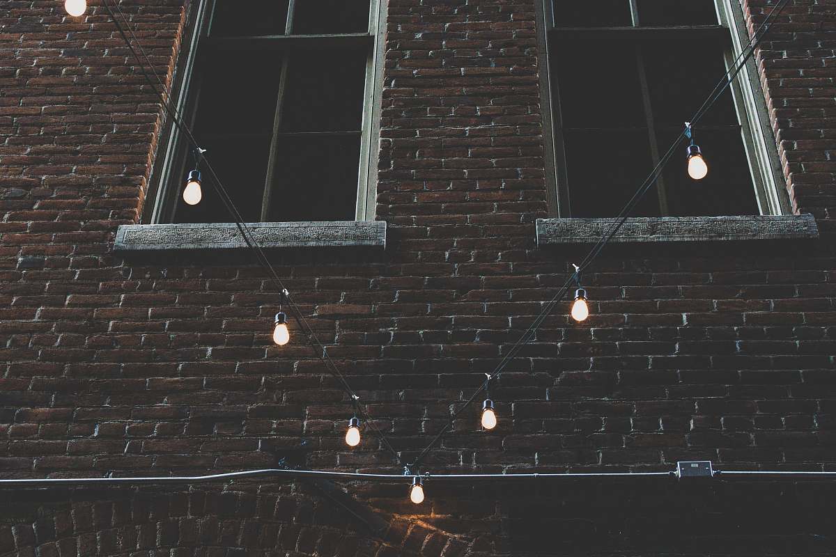 brick two brown windows near black string lights denver