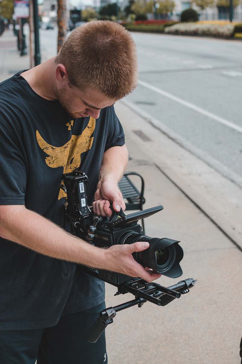 person man holding professional camera people