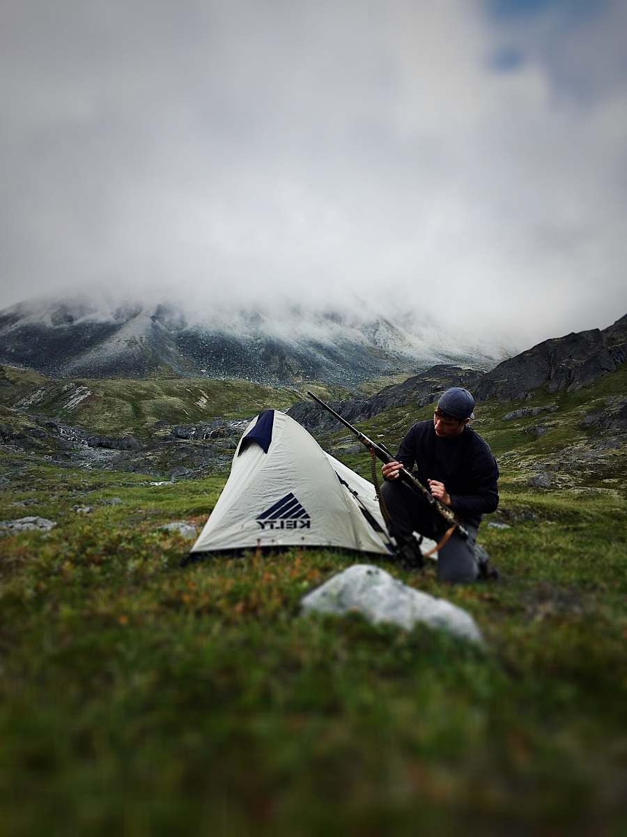 person man sitting near camping tent people