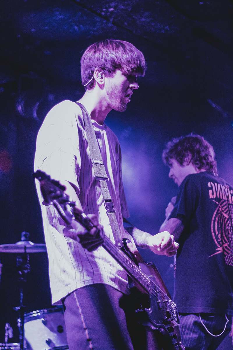 person standing man holding guitar guitar