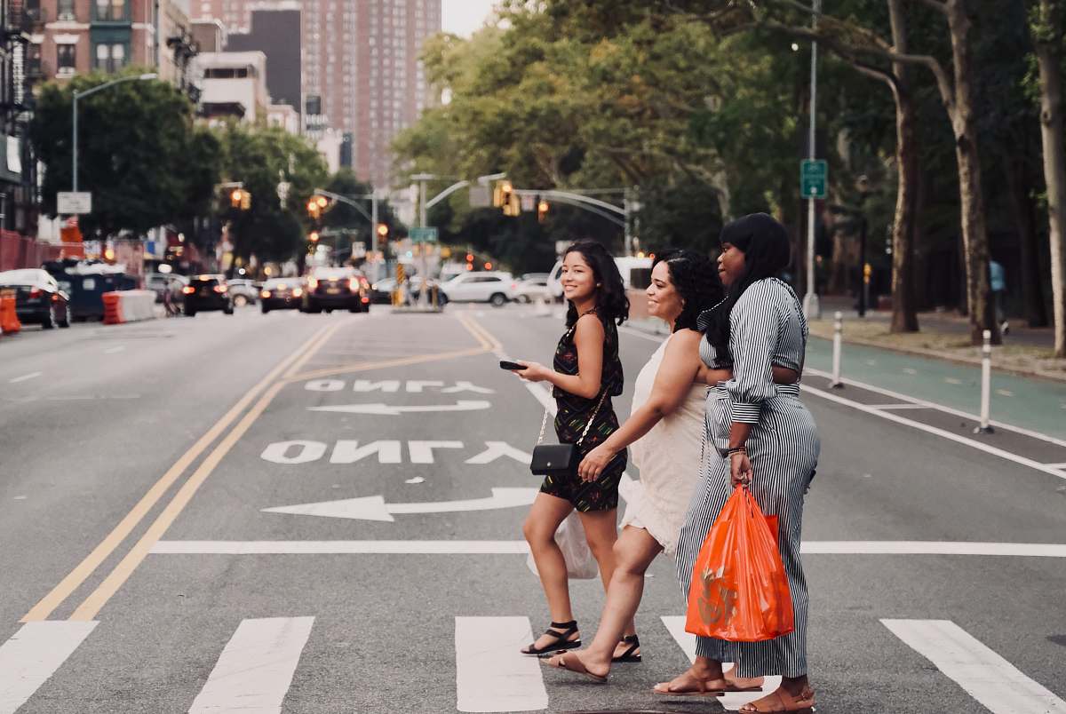 person three women walking on pedestrian lane people
