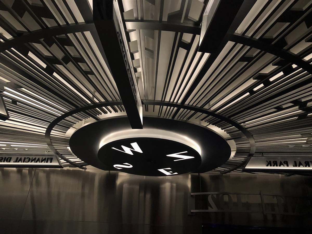 staircase grayscale photo of compass light fixture
