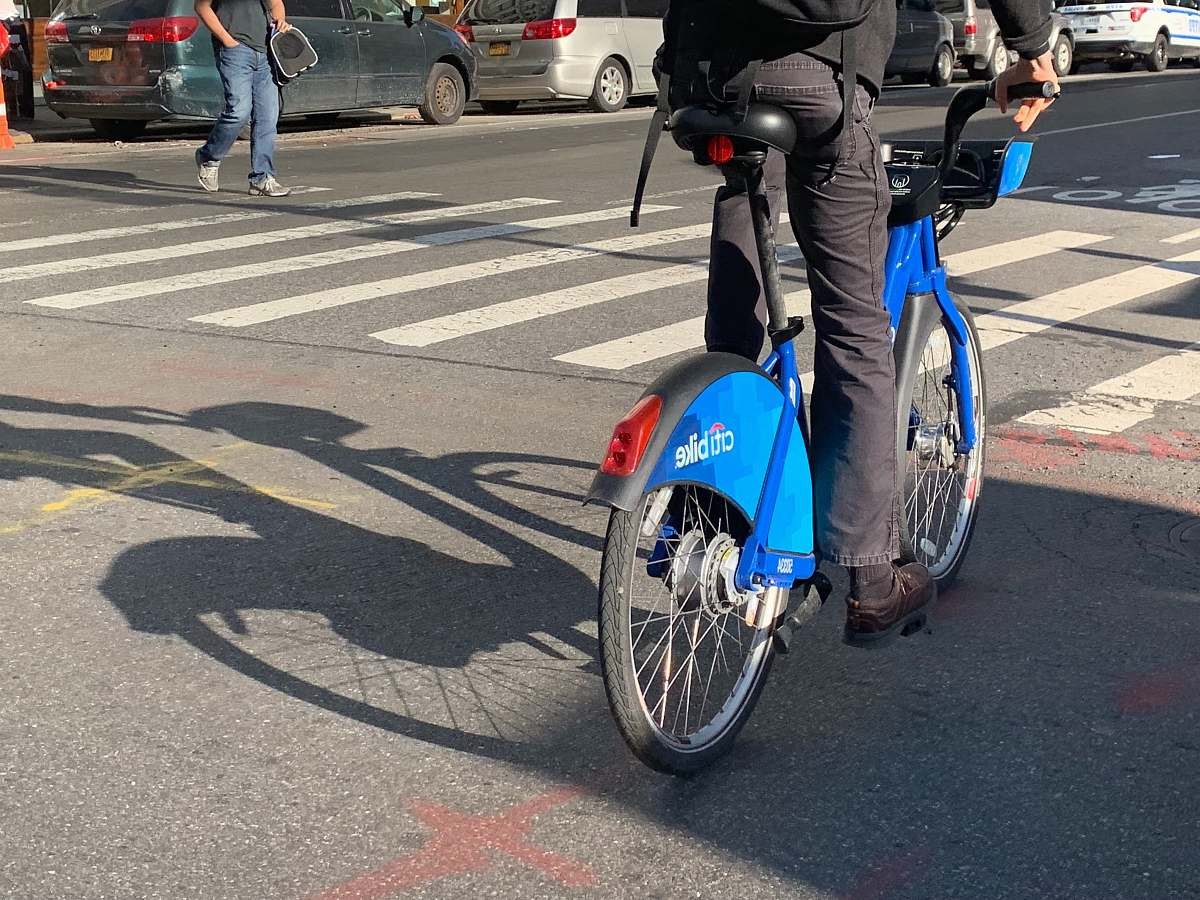 wheel man riding blue bicycle asphalt