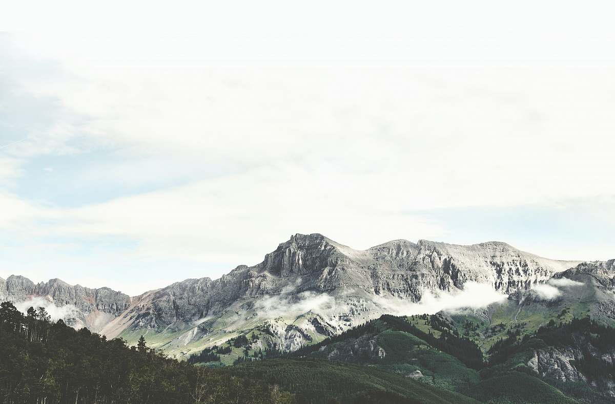 nature green mountains under blue sky grey