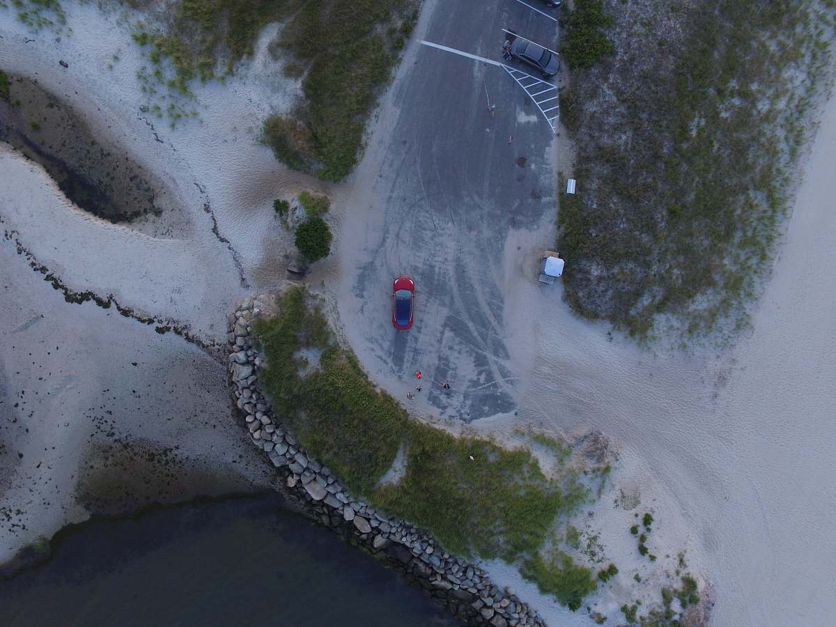 outdoors aerial photo of red vehicle on road scenery