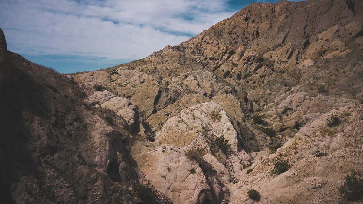 outdoors brown rock formation under blue sky mountain