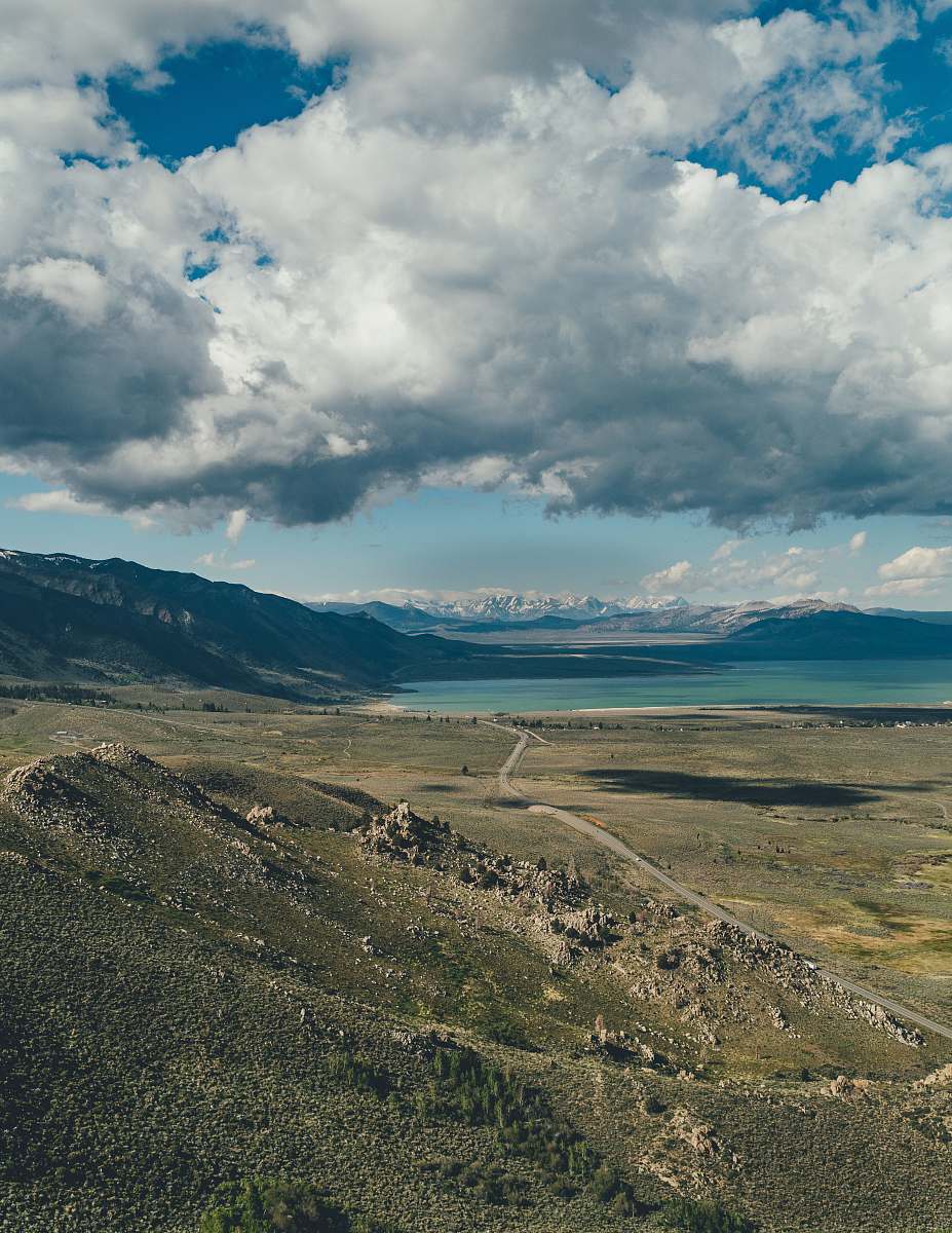 outdoors grey and white clouds hovering above valley and lake mountain