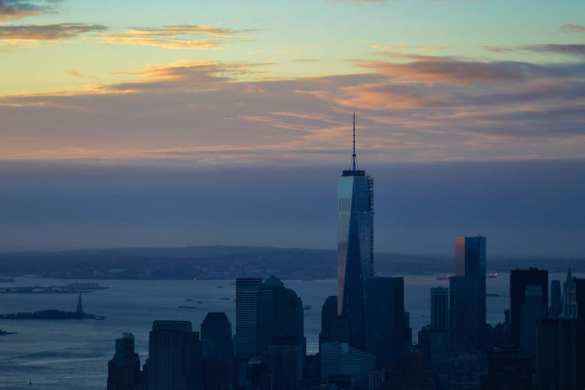 building high rise buildings near sea during golden hour city