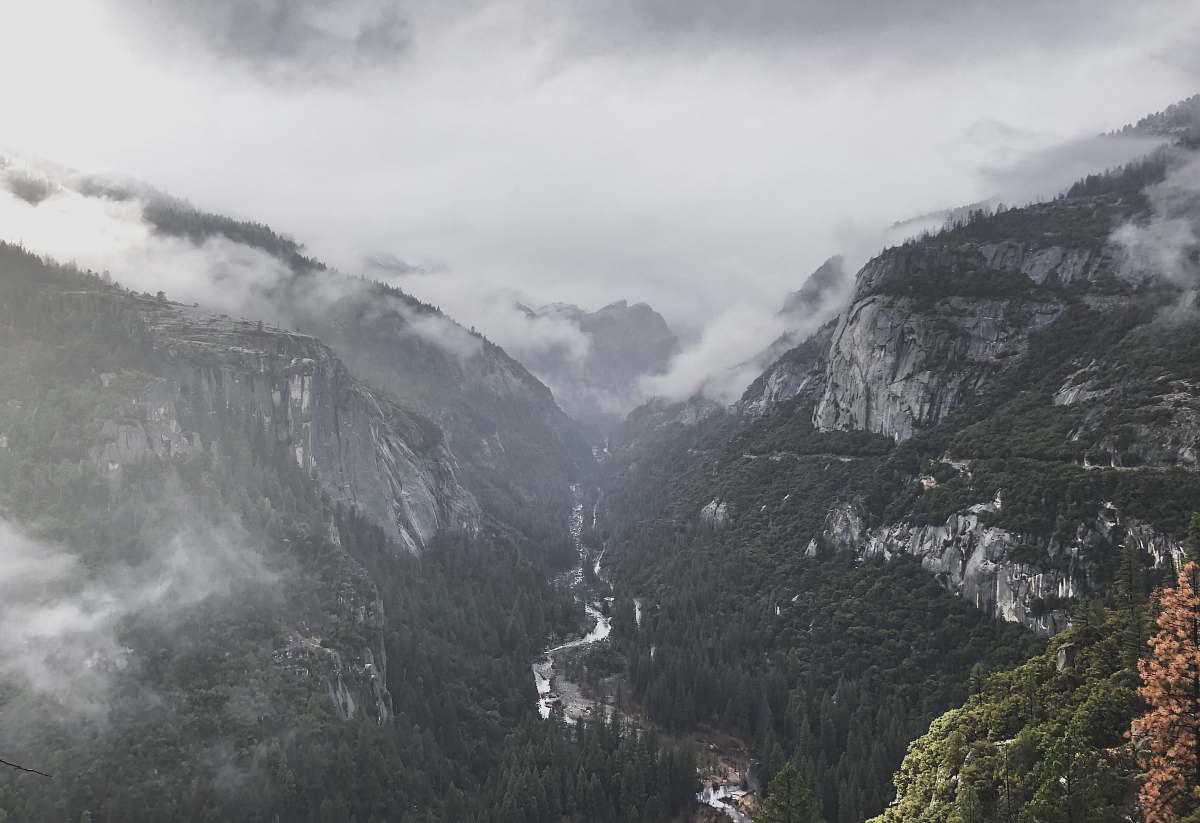 grey landscape photo of cloudy mountains slope
