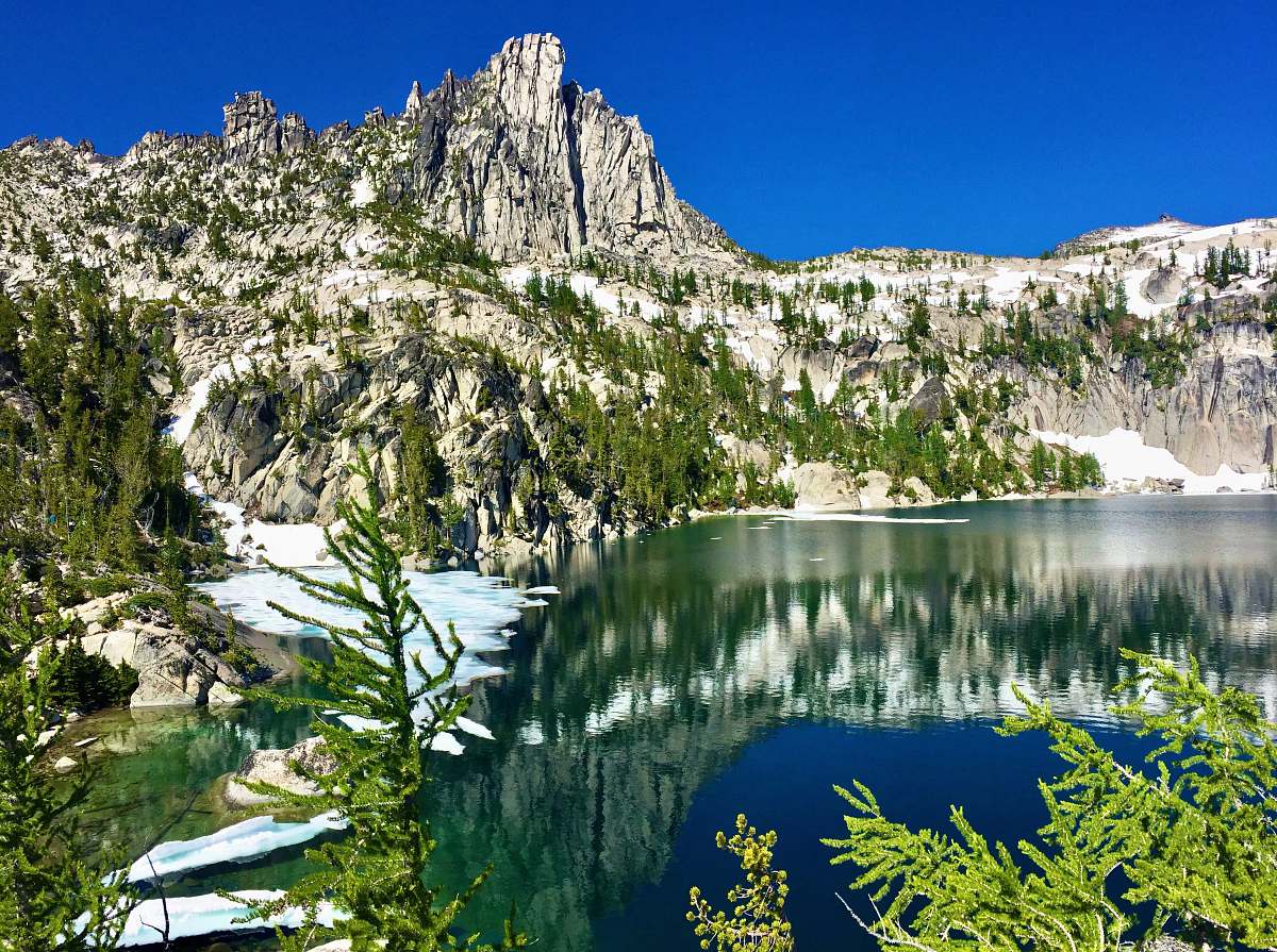 abies reflection of cliff on body of water during daytime fir