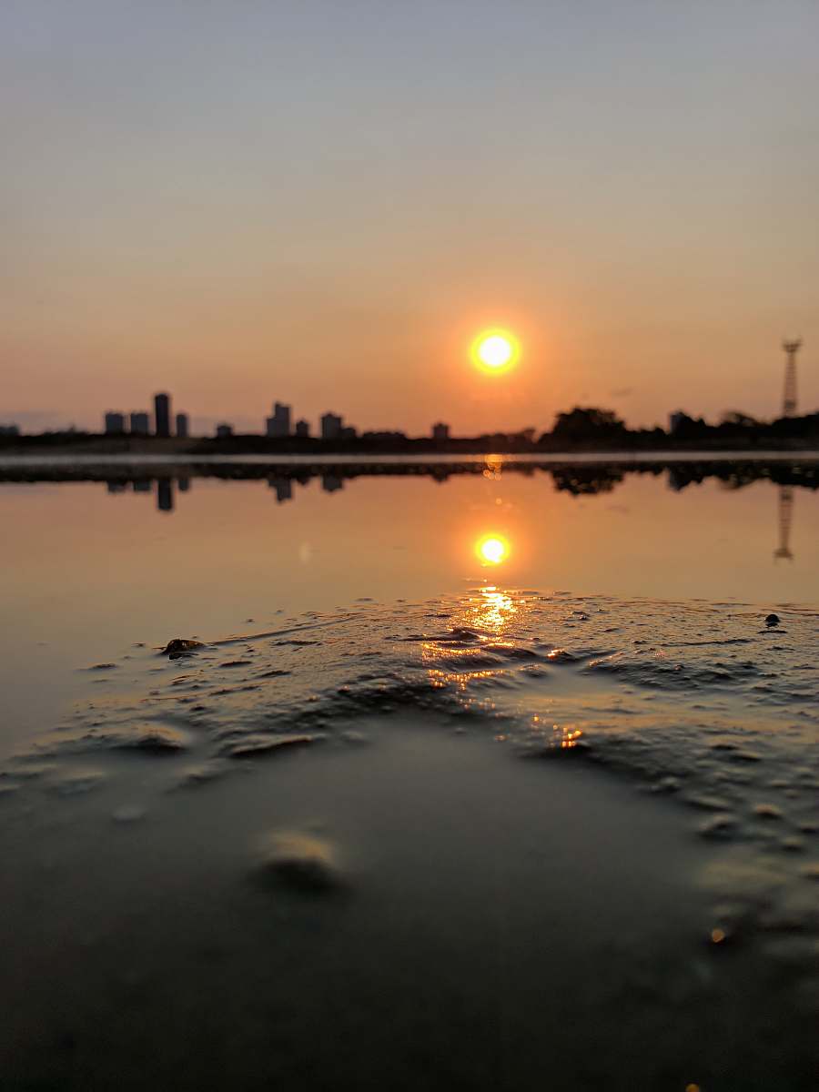 outdoors sunrise at the city through body of water sunlight