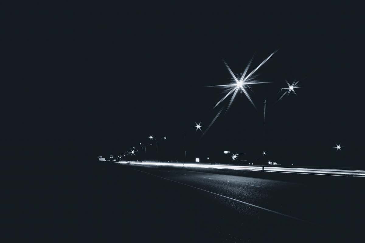 fireworks grayscale photography of time-laps of road outdoors