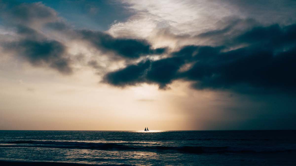 water calm sea under blue sky cloud