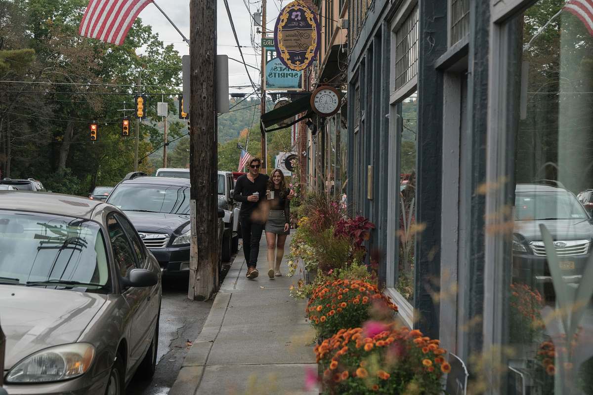 sidewalk man and woman walking on sidewalk flora