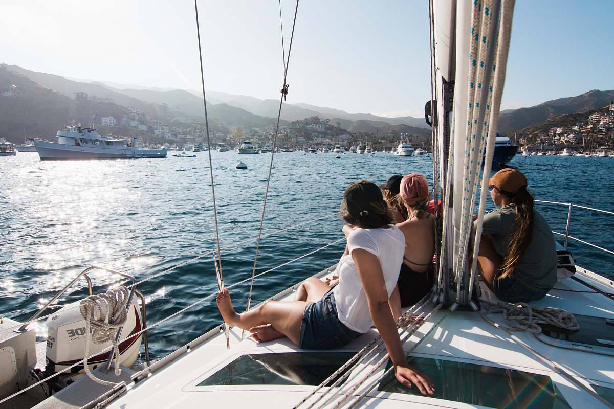 human people sitting on front of yacht boat