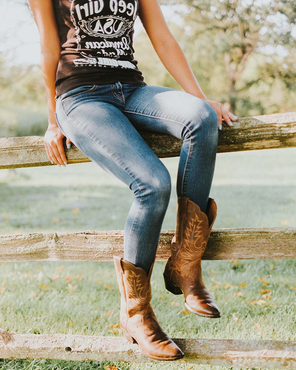 person woman sitting on brown wooden fence human