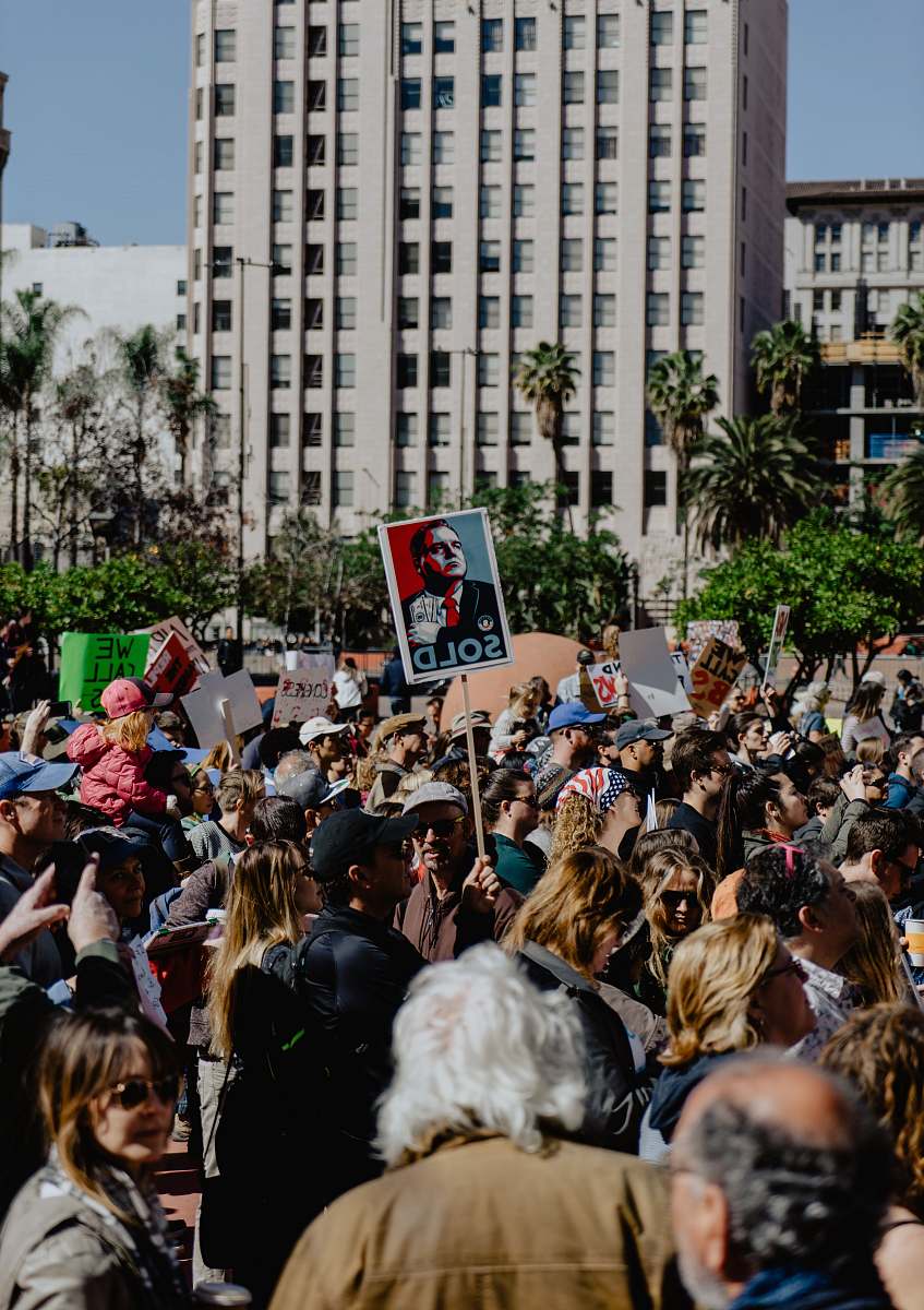 crowd group of person standing near city buildings flora