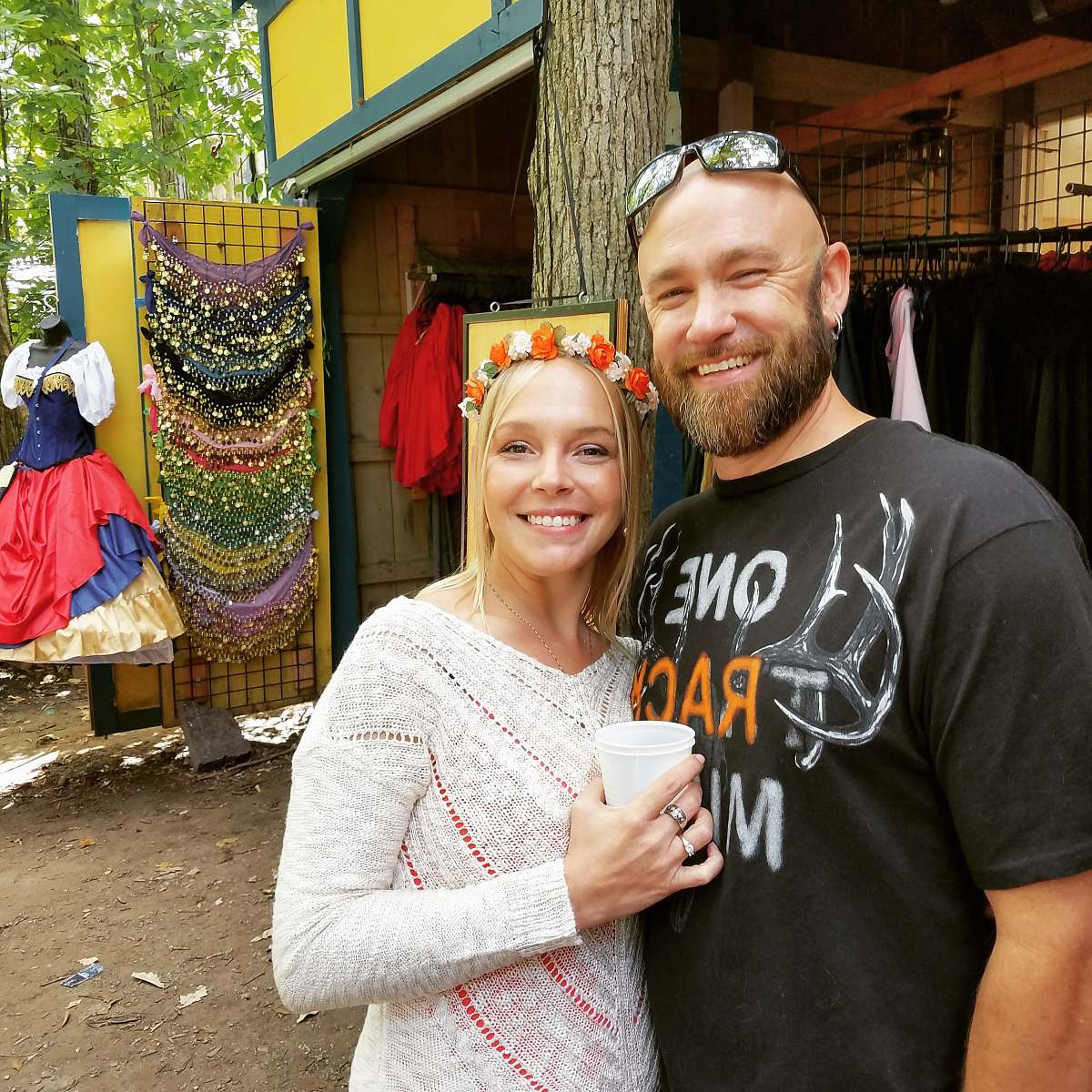 apparel man and woman standing near trees and apparels clothing