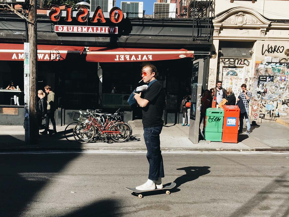 people man riding skate near gray and red building during daytime human