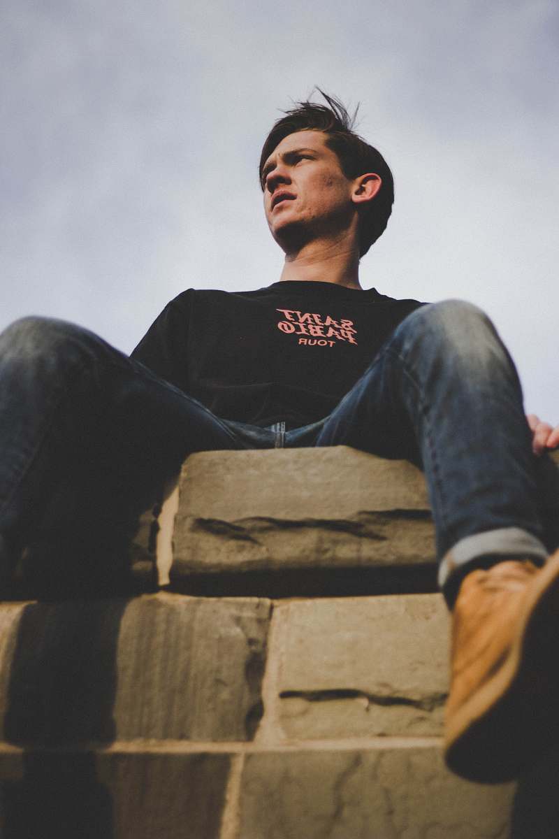 human man sitting on gray surface people