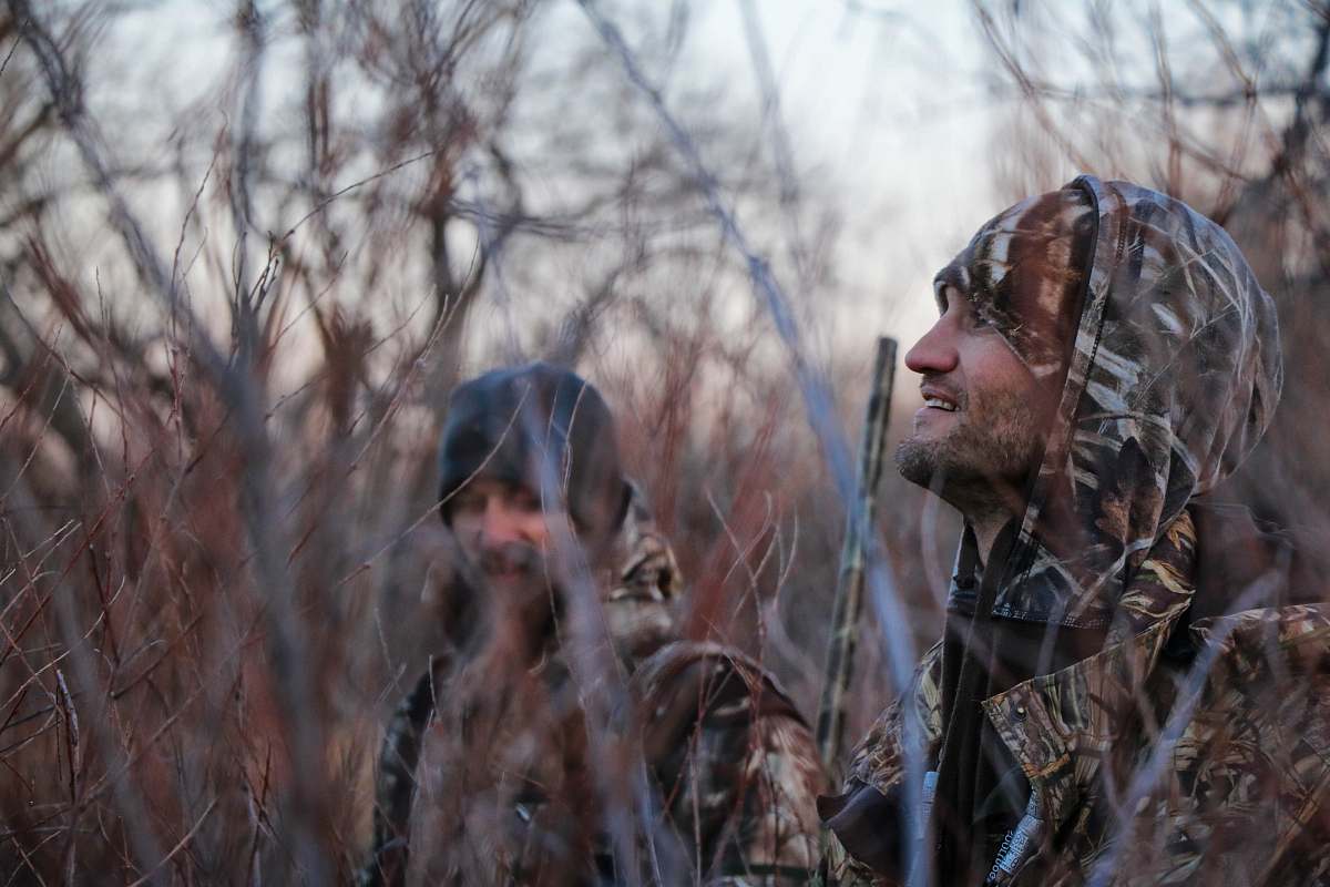 Immerse yourself in the tranquil beauty of nature with this captivating image of two men, avid hunters, exploring the dense woods. Surrounded by towering trees and lush greenery, these hunters embody adventure and camaraderie. This scene is perfect for illustrating themes of outdoor exploration, wildlife conservation, or teamwork in promotional materials, blogs, and adventure guides.