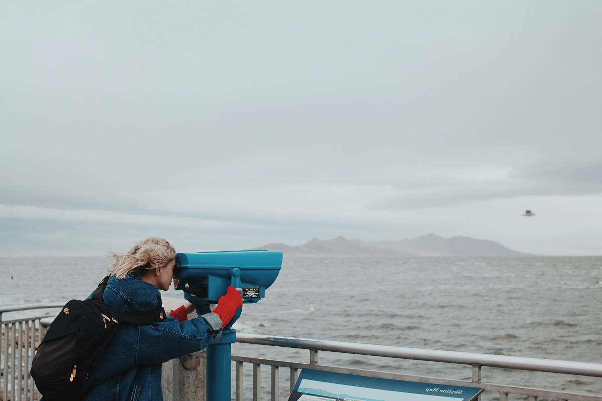 people woman looking thru telescope human