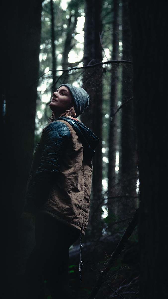 human woman standing beside tree trunk people