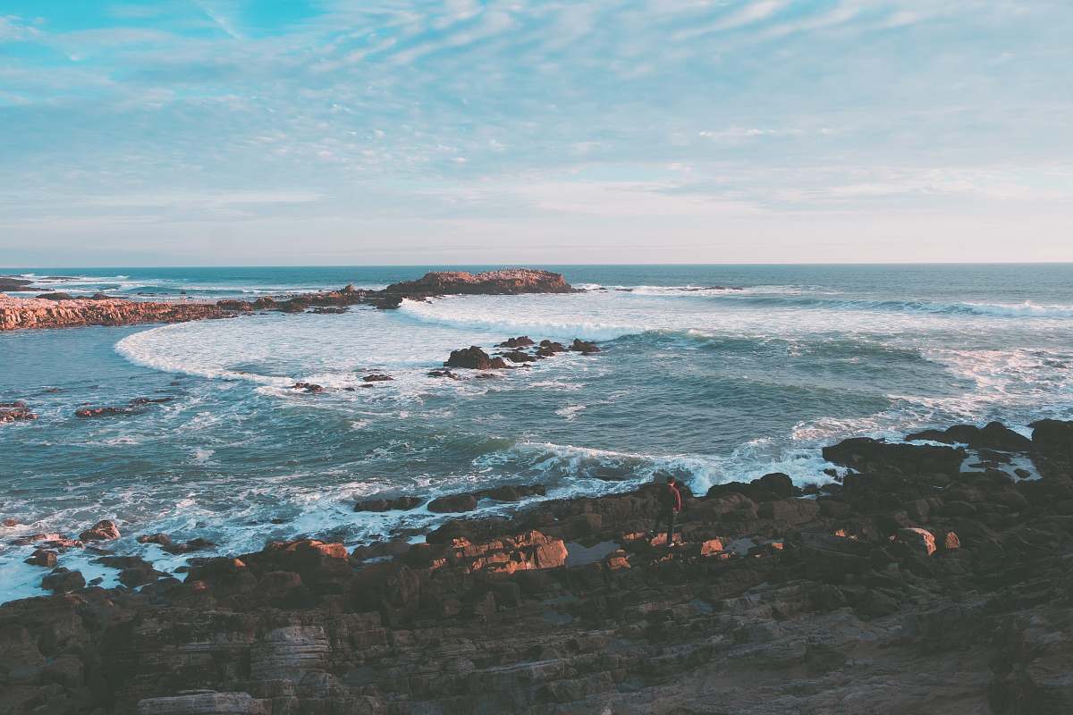 nature wavy ocean splashing on rock during daytime outdoors